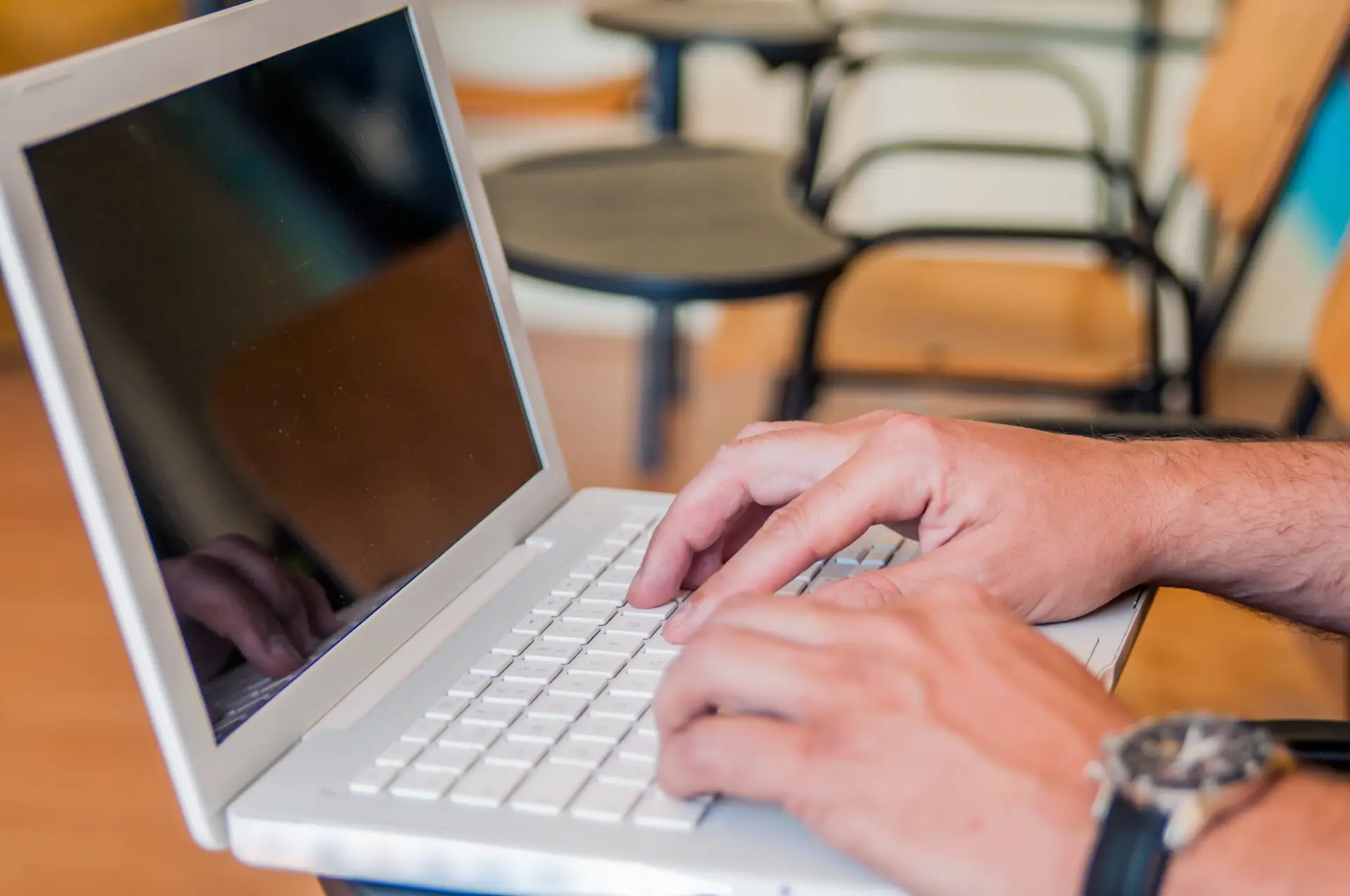 young man using laptop on class